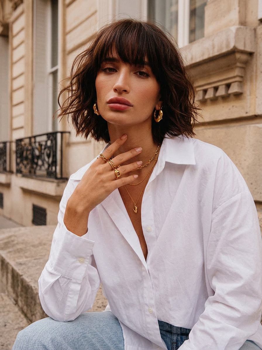 Woman wearing a white shirt with a building in the background